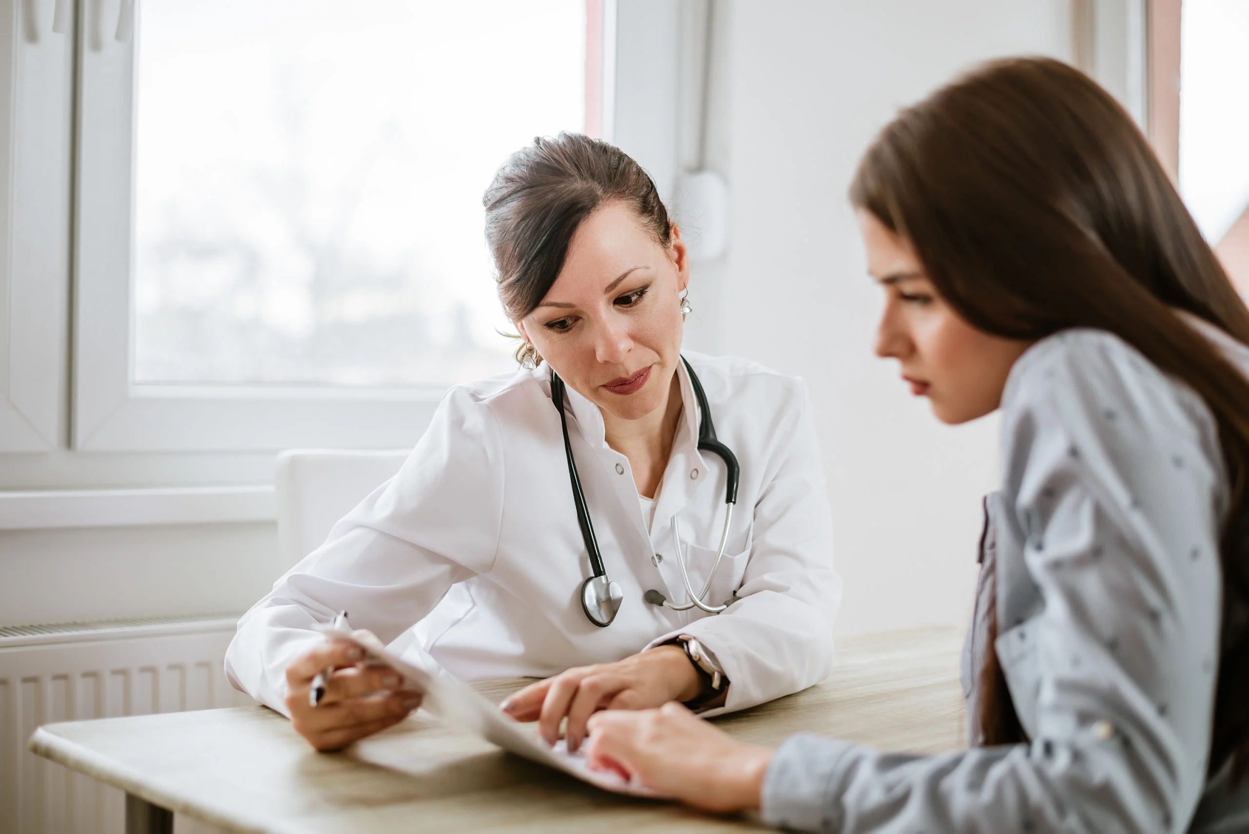 black hair doctor checking patient